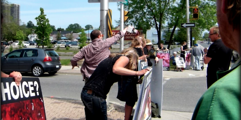 Activists getting chocolate milk poured on them.